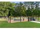 View of the fenced garden area with raised beds, providing ample space for gardening and outdoor enjoyment at 7255 Old Rico Rd, Chattahoochee Hills, GA 30268
