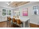 Bright, modern kitchen features a large island, stylish lighting, and wood plank ceiling at 7255 Old Rico Rd, Chattahoochee Hills, GA 30268