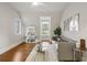 Bright living room featuring hardwood floors, a comfortable sofa, and modern décor at 7255 Old Rico Rd, Chattahoochee Hills, GA 30268