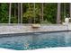Close-up shot of a pool with waterfall, showcasing the peaceful water feature and landscaping at 7255 Old Rico Rd, Chattahoochee Hills, GA 30268