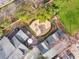 Aerial view of an outdoor entertaining space with brick patio, fire pit, deck, and manicured landscaping at 1466 University Dr, Atlanta, GA 30306