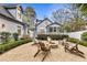 Inviting backyard patio with fire pit, string lights, and cozy seating, perfect for outdoor gatherings at 1466 University Dr, Atlanta, GA 30306