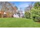Expansive backyard with lush lawn and charming details, including a hammock, white picket fence, and garden arbor at 1466 University Dr, Atlanta, GA 30306