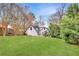 Beautiful backyard showcasing a manicured lawn, mature trees, and a partial view of the home's exterior at 1466 University Dr, Atlanta, GA 30306