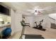 Spacious basement gym featuring workout equipment and a TV mounted on the wall at 1466 University Dr, Atlanta, GA 30306