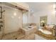 Luxurious bathroom features dual shower heads, soaking tub, elegant lighting, tile floors, and a granite vanity at 1466 University Dr, Atlanta, GA 30306