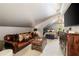Spacious bedroom with stylish decor, a comfortable leather sofa, and a TV at 1466 University Dr, Atlanta, GA 30306
