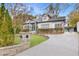 Charming home with a manicured lawn, brick accents, and a long, winding driveway at 1466 University Dr, Atlanta, GA 30306