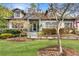 Charming two-story home with manicured front lawn, brick exterior, and an American flag at 1466 University Dr, Atlanta, GA 30306