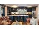 Beautiful kitchen featuring a large island with seating, granite countertops, and modern dark cabinets at 1466 University Dr, Atlanta, GA 30306