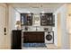 Charming kitchenette features dark wood cabinets, stainless appliances, and a unique decorative tin ceiling at 1466 University Dr, Atlanta, GA 30306