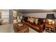 Living room features a comfortable leather sofa, wooden trunk, and adjacent office area at 1466 University Dr, Atlanta, GA 30306