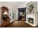 Cozy living room with a fireplace, desk, hardwood floors, and access to the outdoors at 1466 University Dr, Atlanta, GA 30306