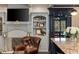 Cozy space with built-in shelving, a decorative fireplace, and an adjacent kitchen island seating at 1466 University Dr, Atlanta, GA 30306
