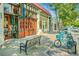 Charming street view highlighting local shops, parked cars, benches, and blue rental bicycles at 1466 University Dr, Atlanta, GA 30306