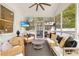 Relaxing screened porch with comfortable wicker furniture, a ceiling fan, and a mounted television at 1466 University Dr, Atlanta, GA 30306