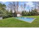 Backyard swimming pool surrounded by well-manicured lawn and trees, perfect for summer relaxation at 1466 University Dr, Atlanta, GA 30306