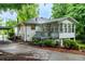 View of the rear of the home and carport featuring a sunroom and back deck at 218 Woodview Se Ln, Smyrna, GA 30082