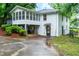 Rear of home showing a sunroom, deck, and door to the basement area at 218 Woodview Se Ln, Smyrna, GA 30082