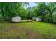 Expansive backyard with a storage shed, shelter, and greenery, providing ample outdoor space at 218 Woodview Se Ln, Smyrna, GA 30082