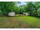 Lush backyard with mature trees, a storage shed, and view of the home's back elevation at 218 Woodview Se Ln, Smyrna, GA 30082