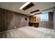 Unfinished basement with wood paneled walls, carpet flooring, and wooden cabinet storage space at 218 Woodview Se Ln, Smyrna, GA 30082