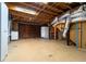 Unfinished basement with exposed wooden ceiling, storage area, and utility connections at 218 Woodview Se Ln, Smyrna, GA 30082