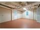 Unfinished basement space with painted block walls and updated plumbing and electrical at 218 Woodview Se Ln, Smyrna, GA 30082