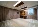 Carpeted basement with built-in desk and wood paneling at 218 Woodview Se Ln, Smyrna, GA 30082