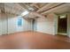 View of unfinished basement with painted concrete floor and access to stairway at 218 Woodview Se Ln, Smyrna, GA 30082