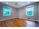 Bedroom featuring hardwood floors, neutral paint, and two windows with natural light at 218 Woodview Se Ln, Smyrna, GA 30082