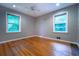 This bedroom has hardwood floors, two windows and is painted a neutral color at 218 Woodview Se Ln, Smyrna, GA 30082