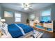This bedroom includes a bed with a blue comforter and a special bookcase with blue storage at 218 Woodview Se Ln, Smyrna, GA 30082