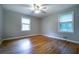 Bedroom featuring hardwood floors, neutral paint, and two windows with natural light at 218 Woodview Se Ln, Smyrna, GA 30082