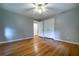 This bedroom features hardwood floors, neutral paint, a ceiling fan and a closet at 218 Woodview Se Ln, Smyrna, GA 30082