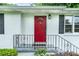 Close up of the home's front porch with a charming red door, black shutters and a heart-patterned railing at 218 Woodview Se Ln, Smyrna, GA 30082