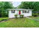 Charming single-story home with a bright red door and well-maintained landscaping at 218 Woodview Se Ln, Smyrna, GA 30082
