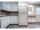 This is a view of the kitchen including the refrigerator and the side door at 218 Woodview Se Ln, Smyrna, GA 30082