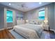Serene main bedroom with two windows, ceiling fan, and hardwood flooring at 218 Woodview Se Ln, Smyrna, GA 30082