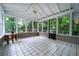 Bright sunroom features tile flooring and multiple windows with backyard views at 218 Woodview Se Ln, Smyrna, GA 30082