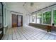 Relaxing sunroom with tile floors and multiple windows offering scenic outdoor views at 218 Woodview Se Ln, Smyrna, GA 30082