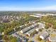 Beautiful aerial view of townhome community surrounded by lush greenery and colorful fall foliage at 2450 Mildon Hall Ln, Lawrenceville, GA 30043
