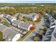Aerial view of townhome community amidst vibrant fall foliage with well-maintained streets and manicured lawns at 2450 Mildon Hall Ln, Lawrenceville, GA 30043