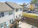 Exterior view of townhome featuring a deck, patio, and garage, offering comfortable outdoor living spaces at 2450 Mildon Hall Ln, Lawrenceville, GA 30043