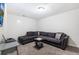 Finished basement with a large sectional sofa and TV at 2450 Mildon Hall Ln, Lawrenceville, GA 30043