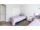 Bright bedroom featuring two beds, a window, and neutral walls at 2450 Mildon Hall Ln, Lawrenceville, GA 30043