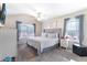 Serene bedroom with neutral tones, large windows, and cozy bedding, creating a tranquil retreat at 2450 Mildon Hall Ln, Lawrenceville, GA 30043
