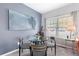 Cozy dining area featuring a glass table and stylish chairs near a window, perfect for intimate meals at 2450 Mildon Hall Ln, Lawrenceville, GA 30043