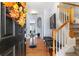 Inviting foyer with hardwood floors, staircase, and tasteful decor creates a warm welcome at 2450 Mildon Hall Ln, Lawrenceville, GA 30043