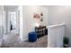Open hallway featuring neutral walls, carpeted floors, and stylish decor at 2450 Mildon Hall Ln, Lawrenceville, GA 30043
